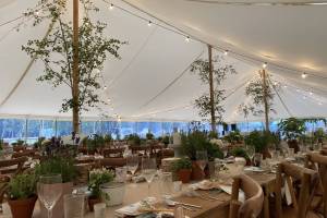 Large traditional marquee with festoon lighting and rustic decoration
