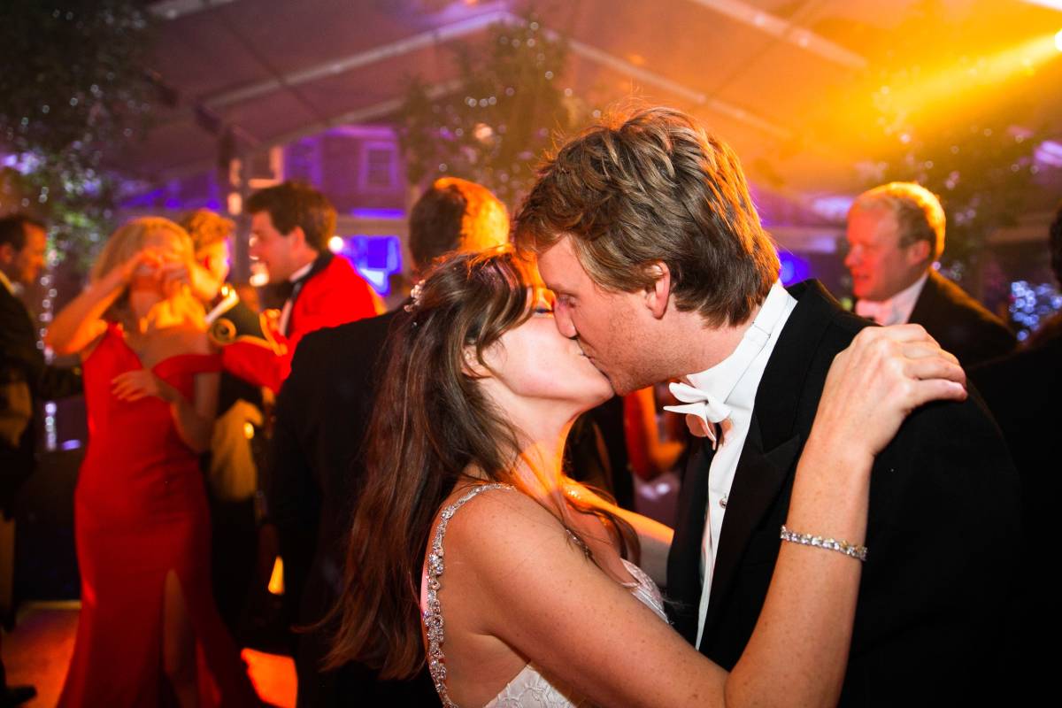 Bride and groom kissing on the dance floor