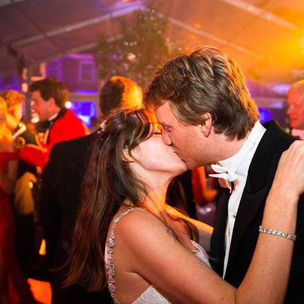 Bride and groom kissing on the dance floor