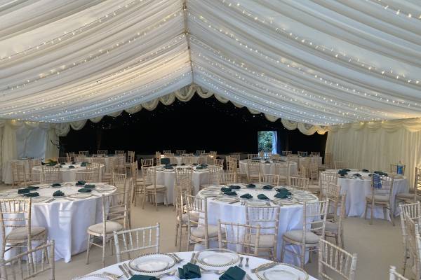 Round tables in a dining marquee