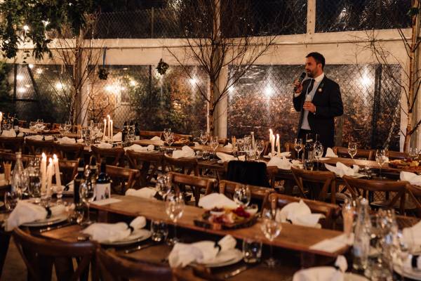 Rustic trestle tables in a clear marquee