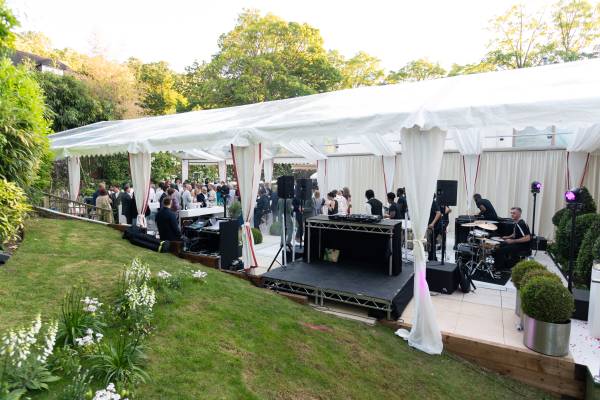 Frame tents fitting into the contours of a garden