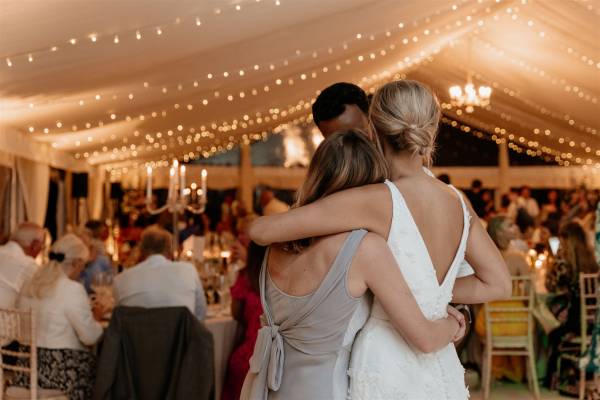 Interior of a frame tent with fairy light canopy and panoramic windows