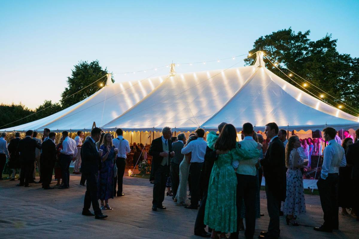Milling around a traditional tent at dusk