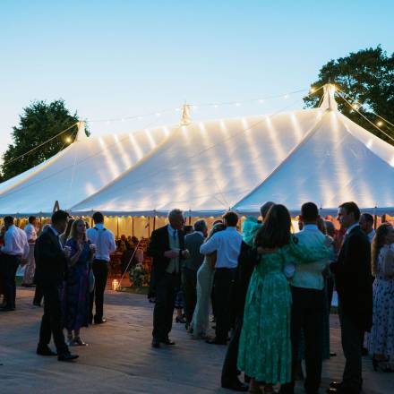 Milling around a traditional tent at dusk