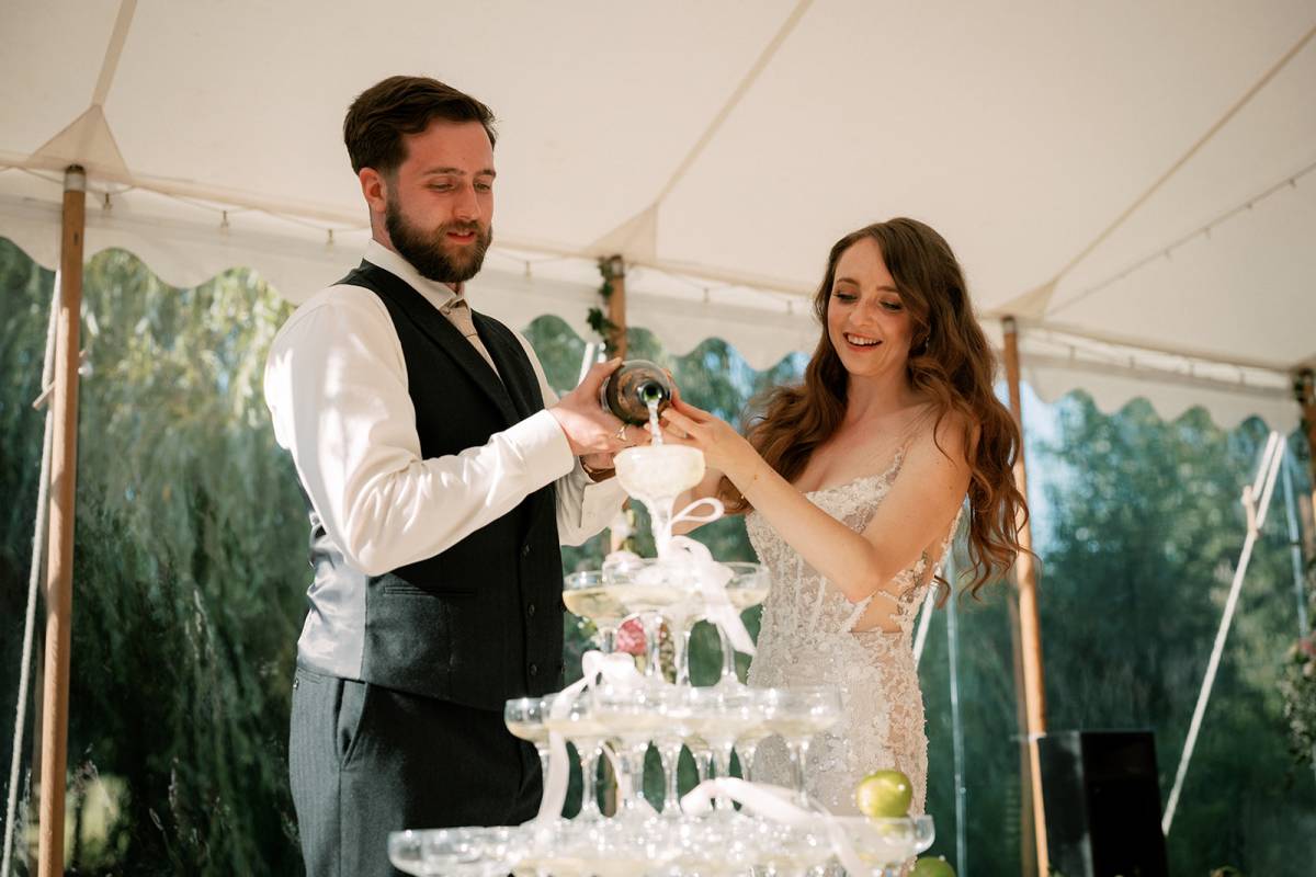 Pouring champagne into a champagne tower