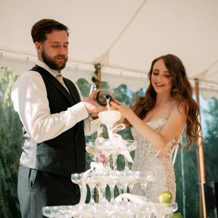 Pouring champagne into a champagne tower