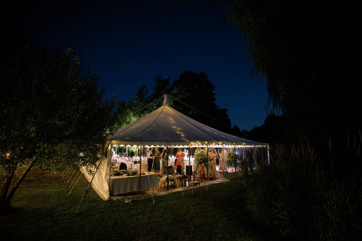 Traditional marquee in a garden lit up at night