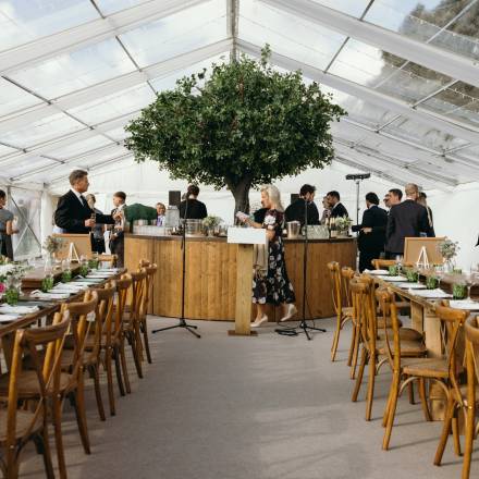Circular bar as the centrepiece of a clear roof marquee