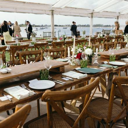Rustic tables, cross back chairs and views of boats