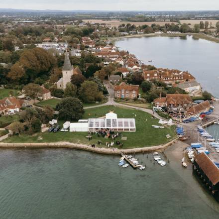 Drone view of clear marquee at Bosham harbour, West Sussex