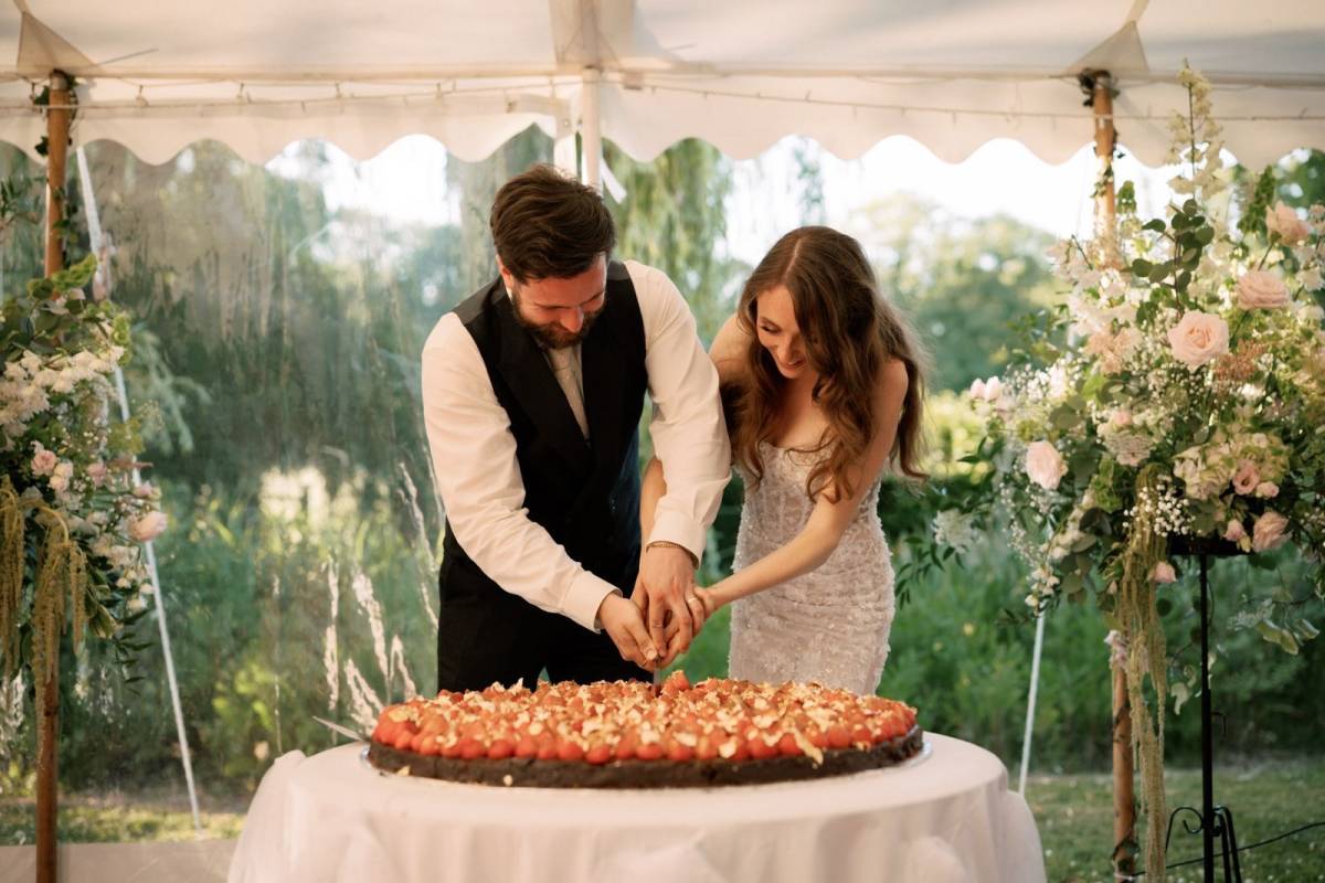 Bride and groom cut the cake together