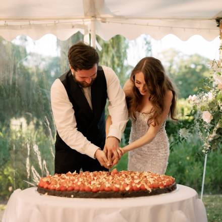 Bride and groom cut the cake together