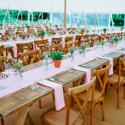 Rustic tables, table runners and little herb pots for a wedding reception