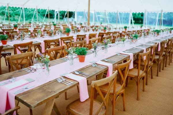 Rustic tables, table runners and little herb pots for a wedding reception