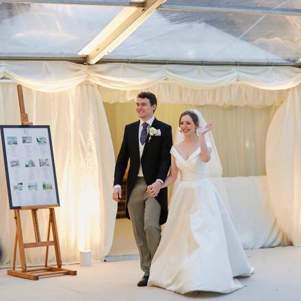 Bride and groom make their entrance into the marquee