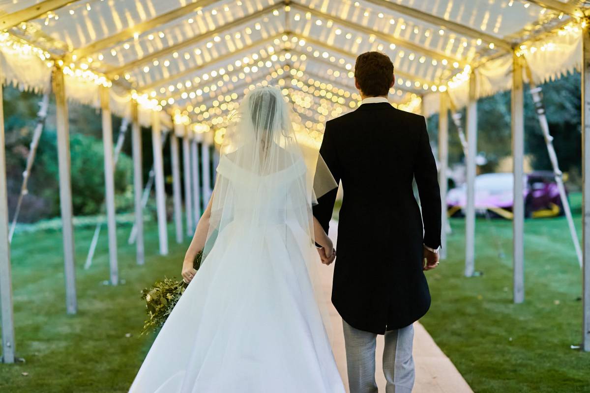 Bride and groom walk down a very long walkway to make their entrance