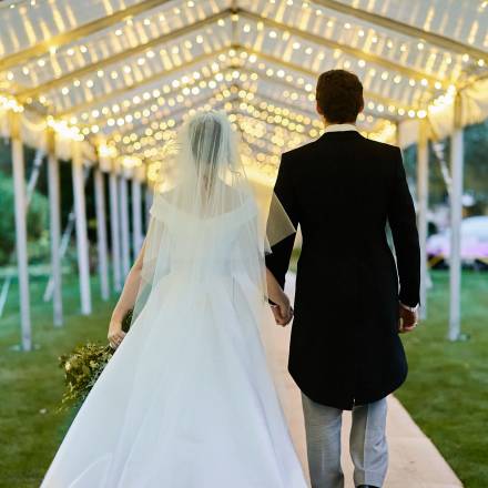 Bride and groom walk down a very long walkway to make their entrance