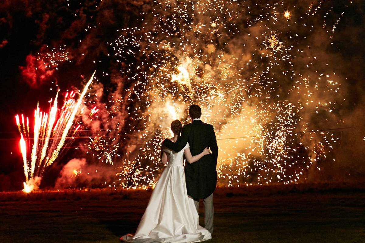 Bride and groom watch fireworks