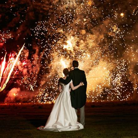 Bride and groom watch fireworks