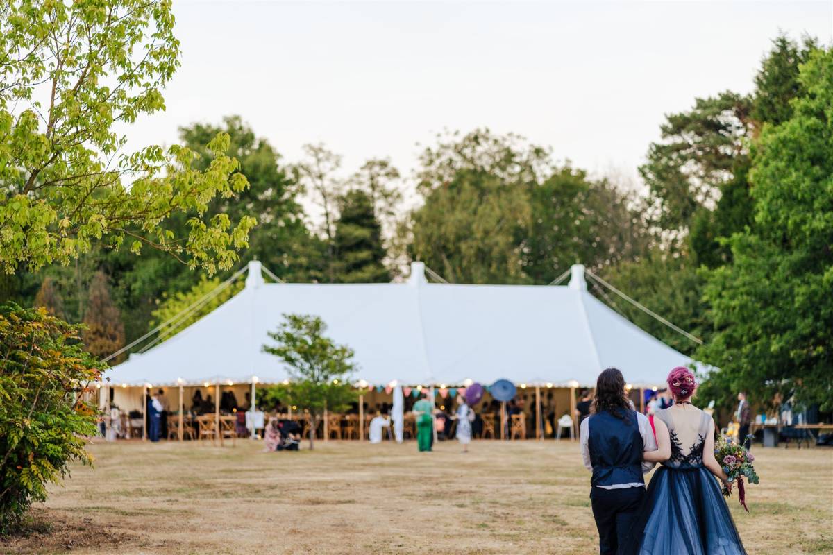 Bride and groom survey their traditional style tent