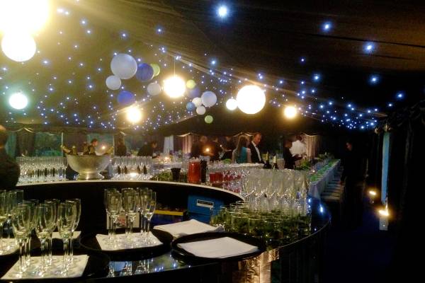 Glamourous reflective circular bar in a sparkly party tent