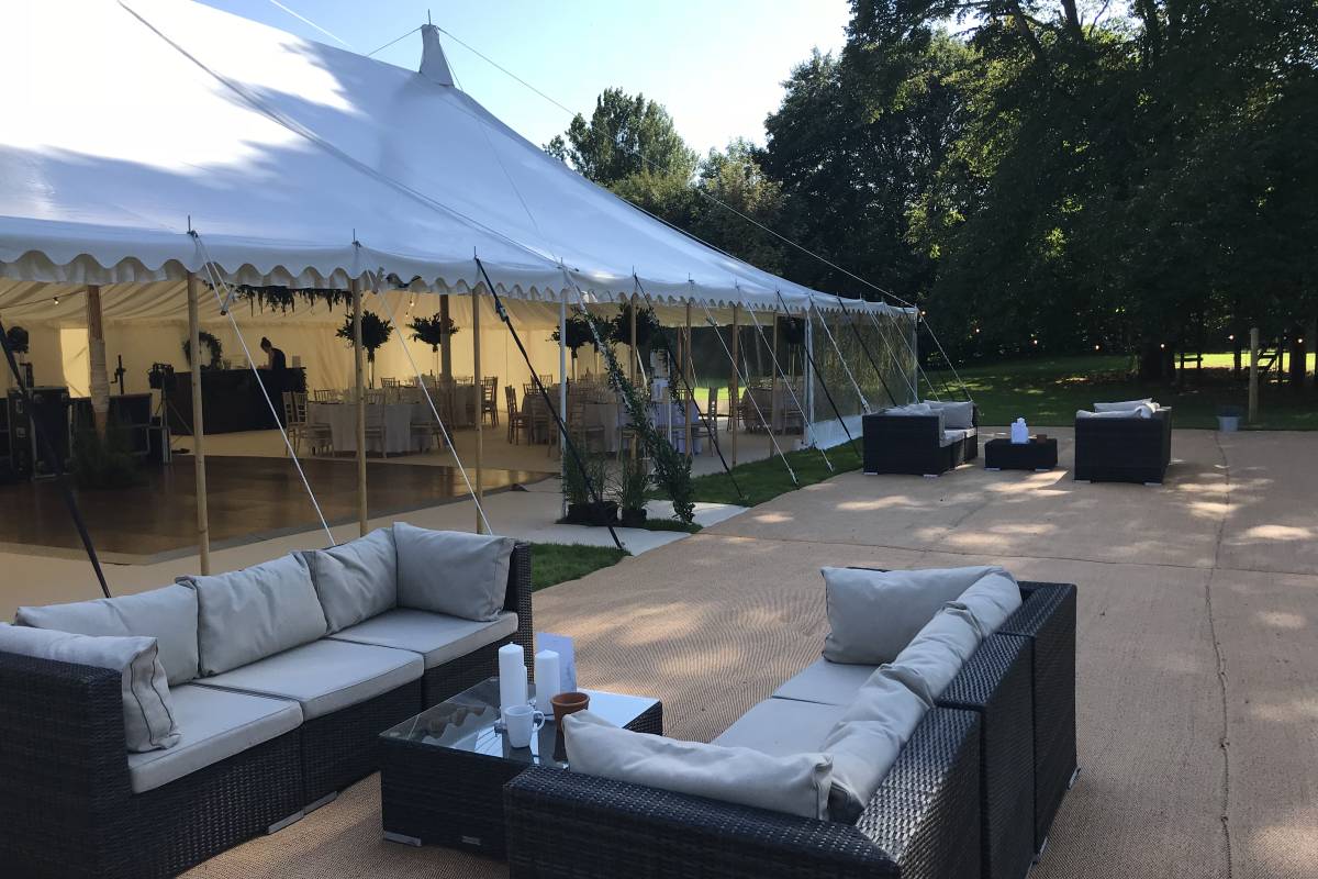 Open sided traditional tent with outdoor furniture