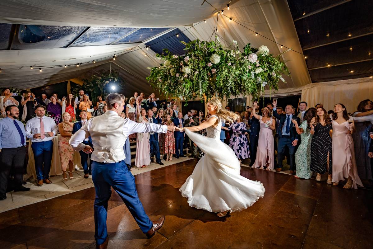 Bride and groom jiving on a wood dance floor