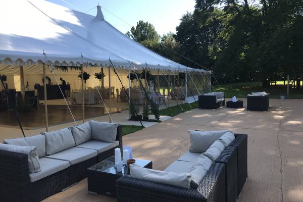 Rattan seating outside a traditional style marquee