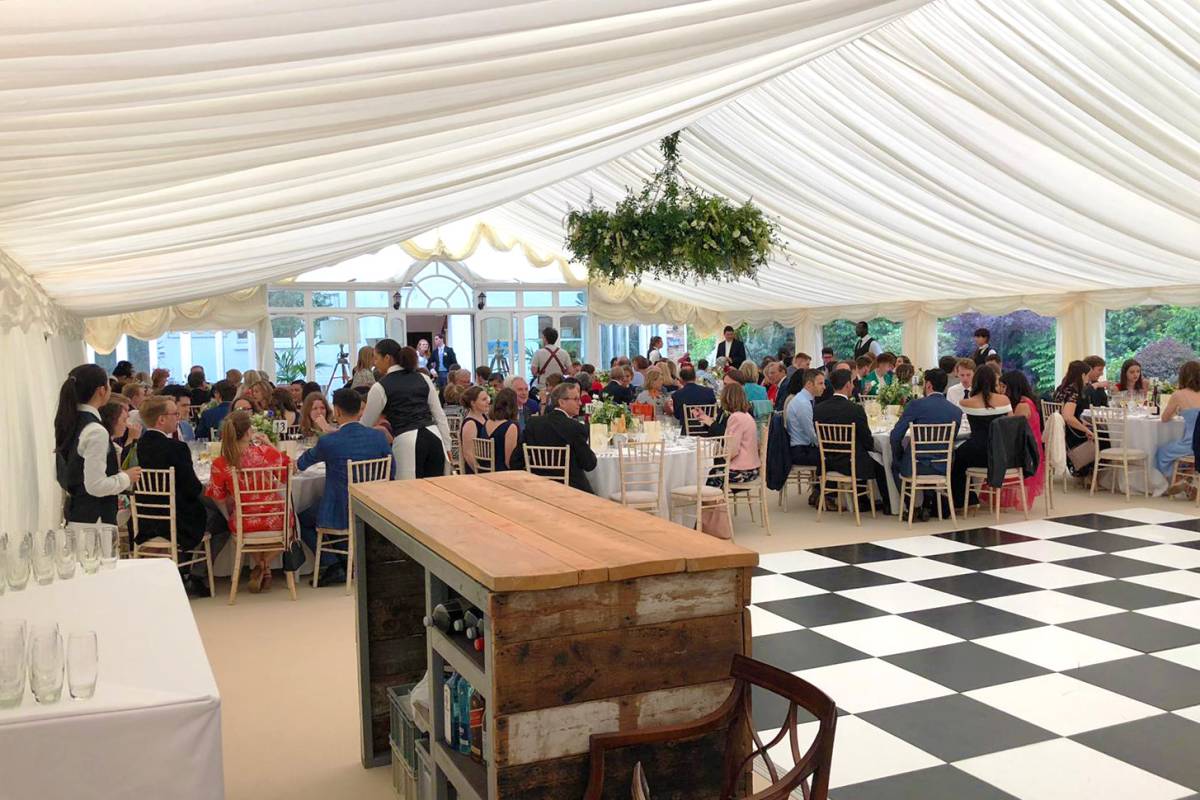 Marquee with large floral centerpiece in Barnes