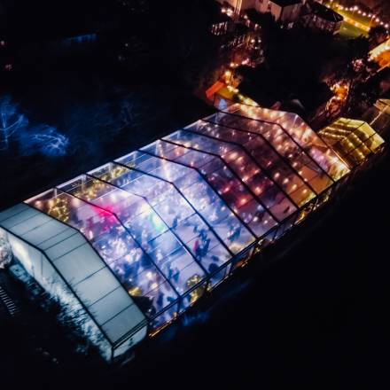 Drone view of large illuminated clear marquee