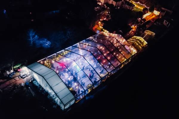 Drone view of large illuminated clear marquee