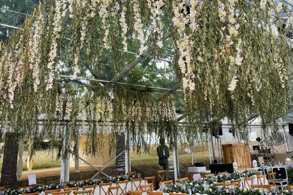 Transparent tent with hanging foliage