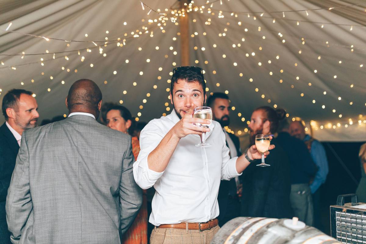 Carrying drinks under a fairylight canopy