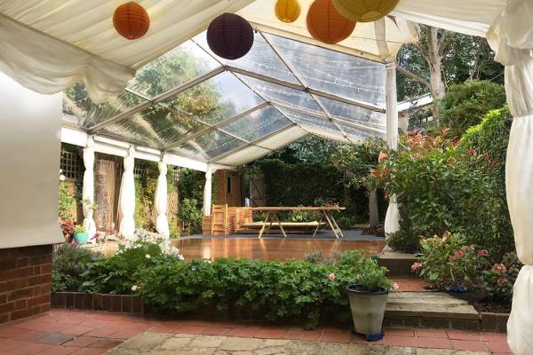 Partially clear marquee in a small garden
