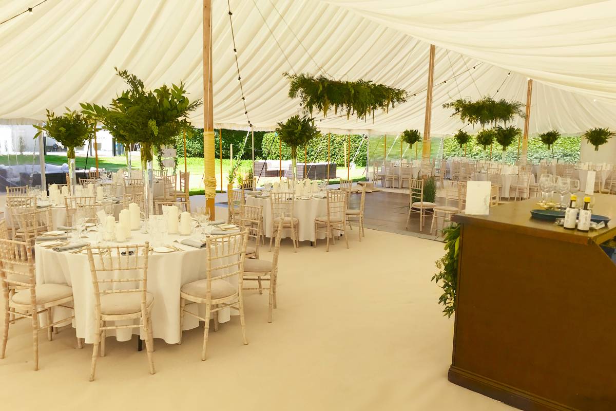 Leafy interior of a traditional marquee near Chichester