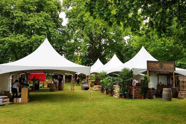 Multiple pagoda tents at a cocktail event