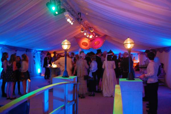 Venice styled reception area with luminous lighting and giant hanging masks