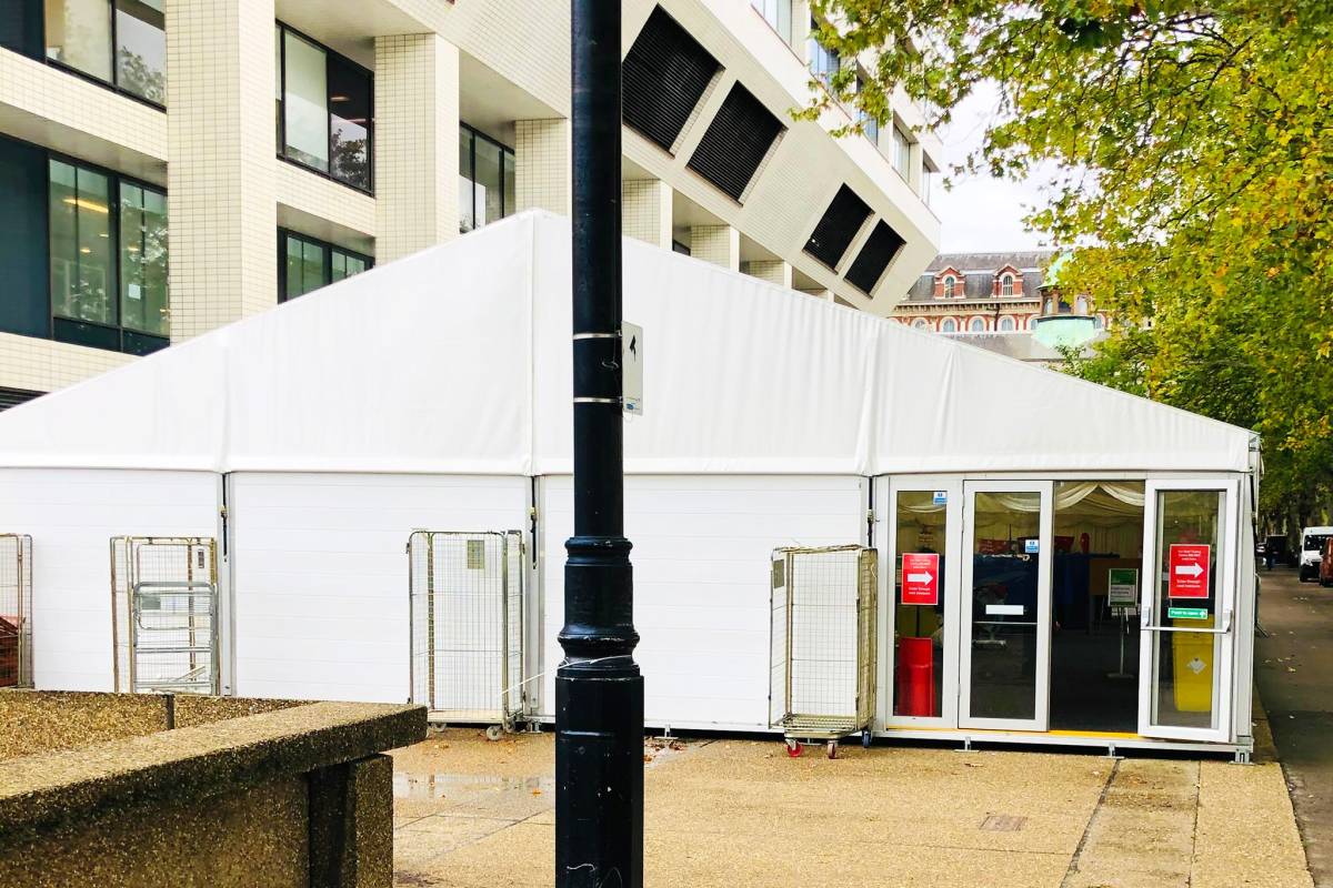Temporary marquee on hard-standing in public space with hard doors