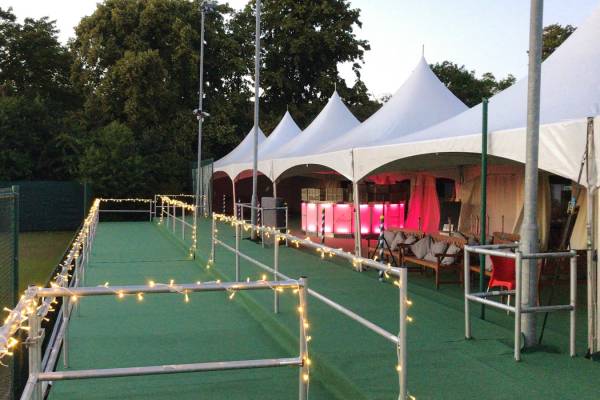 Chinese hat marquees lined up for a tennis event