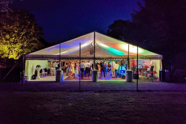 Brightly coloured lighting in a frame marquee on a tennis court