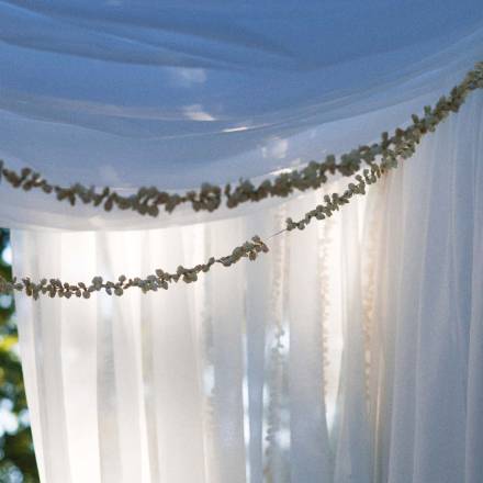 Floaty fabrics and leafy strings over a doorway