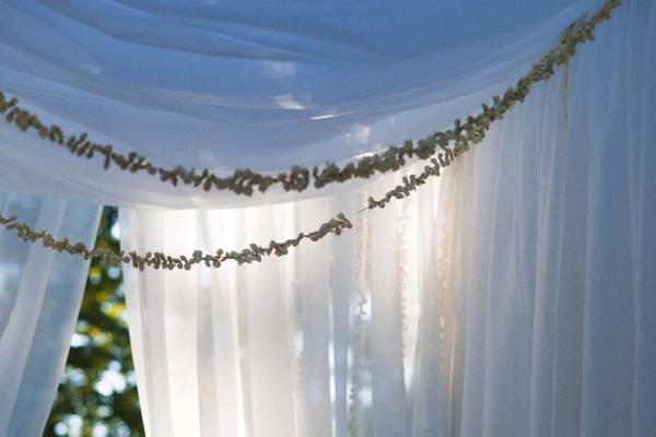 Floaty fabrics and leafy strings over a doorway