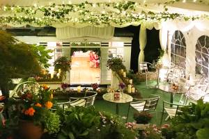 A steeply sloping garden transformed into an glittering flowery party site