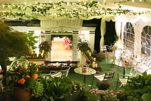 A steeply sloping garden transformed into an glittering flowery party site