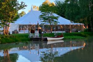 Traditional tent at dusk with lakeside reflections