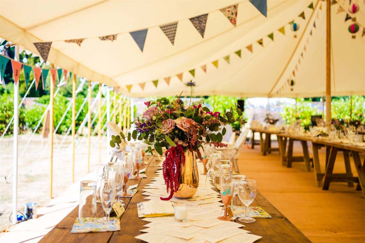 Interior of a boho styled traditional marquee with literary accents