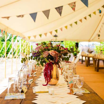Interior of a boho styled traditional marquee with literary accents