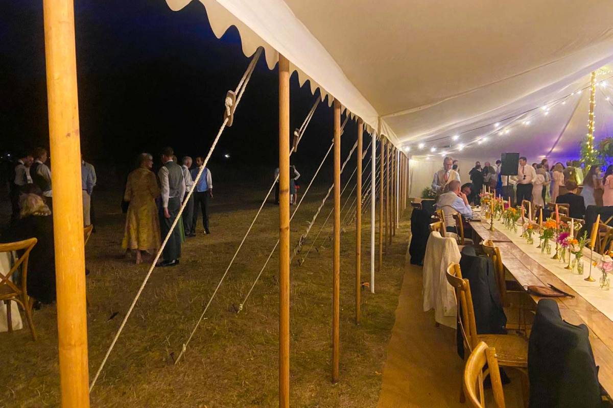 Open sided tent with poles