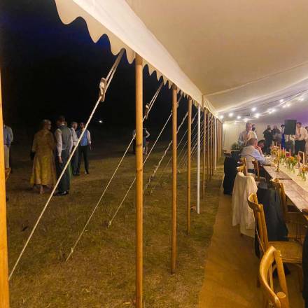 Open sided tent with poles